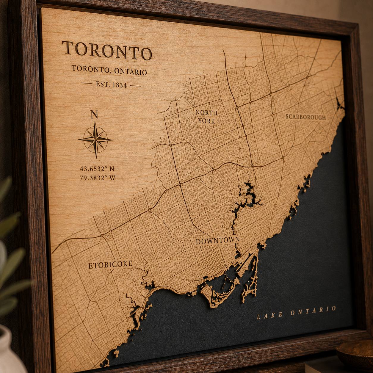 Close-up of an etched Toronto city map showing street linework and the recessed Lake Ontario layer